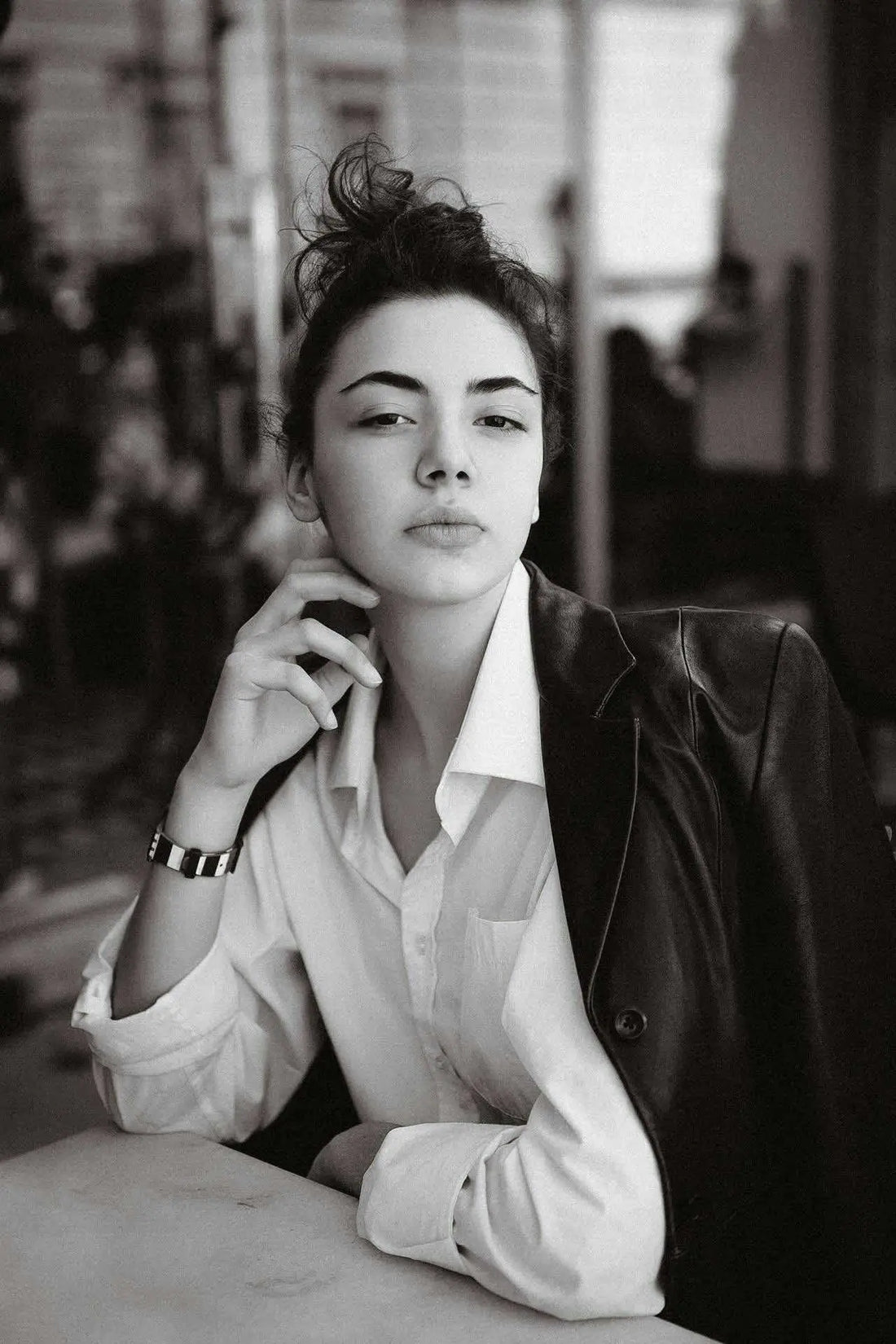 Sigma woman with strong gaze sitting at the table