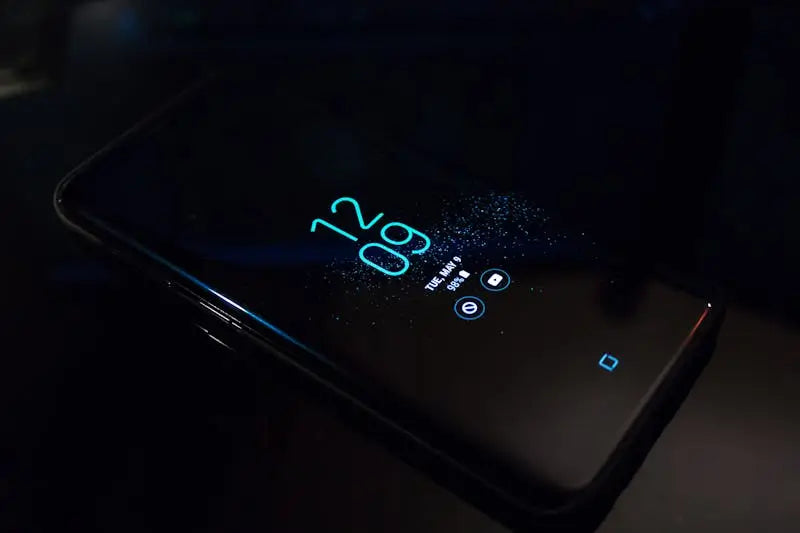 turned on black Samsung Android smartphone displaying clock