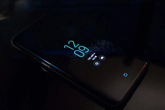 turned on black Samsung Android smartphone displaying clock