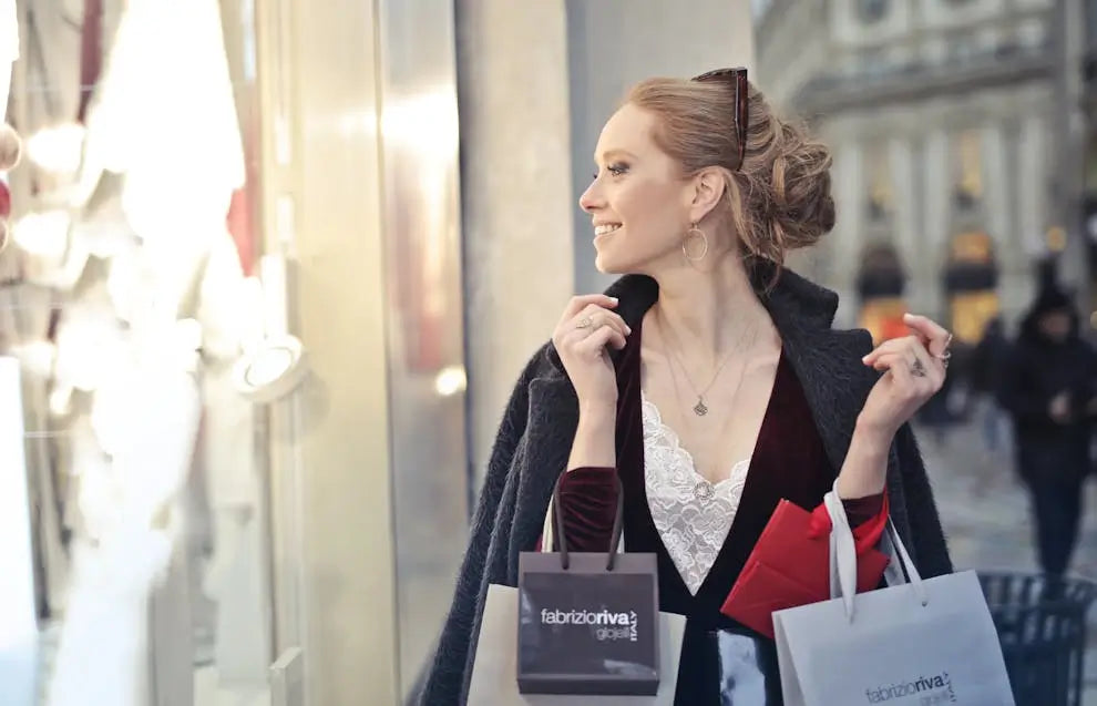 A woman standing in front of a shop, holding numerous shopping bags, tempted to buy more, illustrating the concept of FOMO