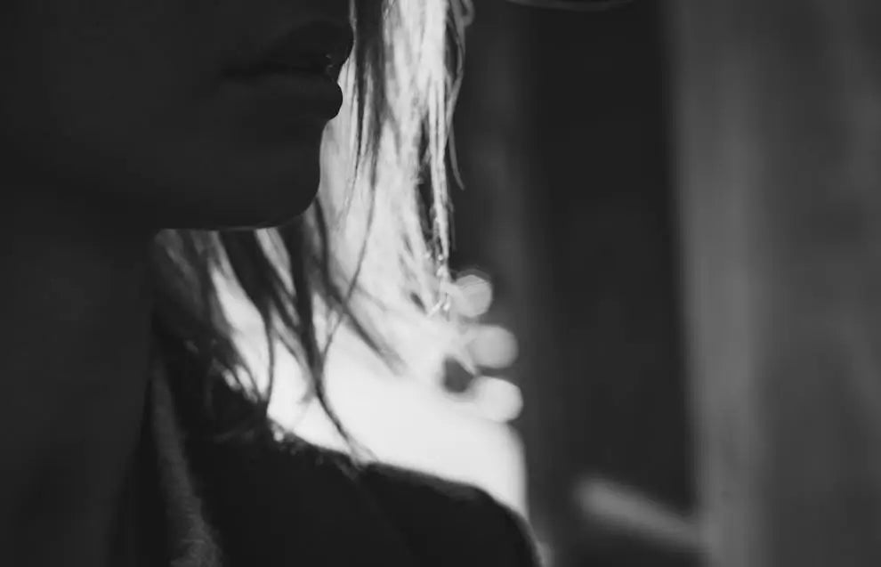 Half face of a mature woman in deep thought